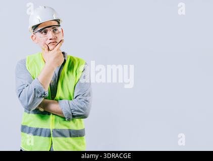 Pensive male engineer with hand on chin isolated. Pensive man engineer looking side. Portrait of handsome engineer thinking with Stock Photo