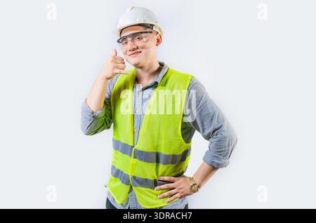 Portrait of young engineer making call gesture isolated. Handsome engineer making call gesture with fingers Stock Photo