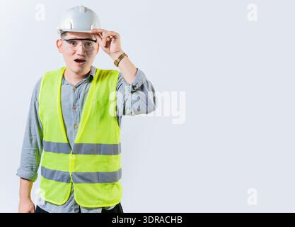 Amazed engineer looking into the distance isolated. Young engineer looking at something in the distance. Surprised man engineer Stock Photo