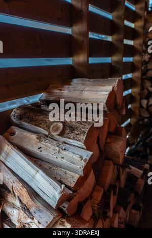 Close-Up of Stacked Firewood in Winter Setting. Stock Photo
