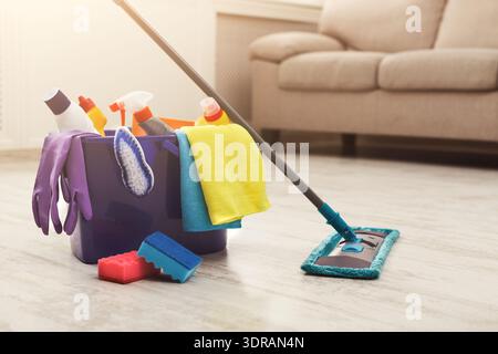 Cleaning Tools and Equipment Arranged in a Collection on the Floor in a Living Room Stock Photo