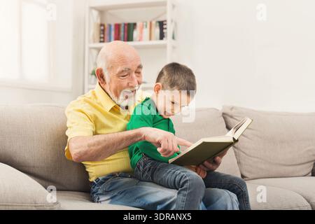 Elder Man Shares Story With Child During Quiet Afternoon at Home on Comfortable Couch Stock Photo