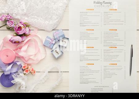 Wedding Planning Checklist and Decorative Items Laid out on a Table for Easy Organization Stock Photo