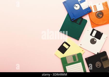 Collection of Floppy Disks Arranged in a Mosaic Pattern on a Pink Background Stock Photo