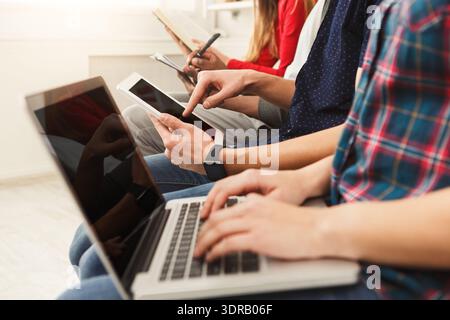Group of People Using Devices in a Modern Room During a Tech Session and Learning Time Stock Photo