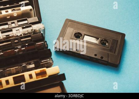 Collection of Audio Cassettes Arranged on a Blue Background for a Nostalgic Look at Music History Stock Photo