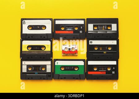 Collection of Retro Audio Cassettes Arranged in a Colorful Mosaic on a Yellow Background Stock Photo