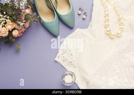 Collage of Wedding Attire and Accessories on a Table With Flowers and Shoes in a Fun Arrangement Stock Photo