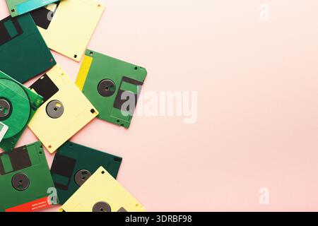 Collection of Old Floppy Disks Arranged on a Pink Background for a Nostalgic Feeling Stock Photo