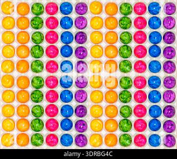 Lots of coloured Easter eggs in transport packaging Stock Photo