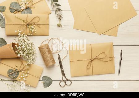 Collection of Crafting Supplies for Creating Personalized Letters and Gifts on a Wooden Table Stock Photo