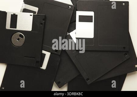 Collection of Black Floppy Disks Arranged in a Mosaic Pattern on a Light Background Stock Photo