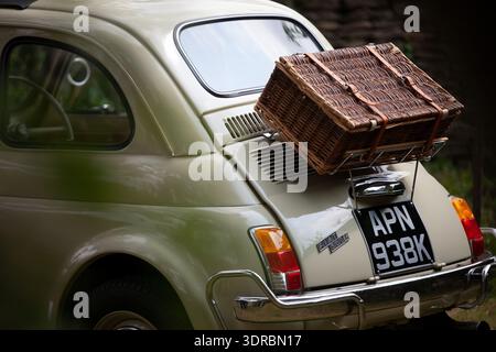 Rear view of a classic Fiat 500 with a wicker picnic basket on the