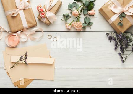 Collection of Gifts, Flowers, and Envelopes on a Wooden Table for a Special Event Stock Photo