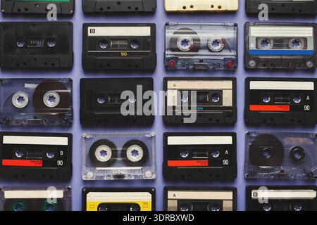 A Diverse Set of Cassette Tapes is Arranged in a Grid, Showcasing Various Designs and Labels Stock Photo
