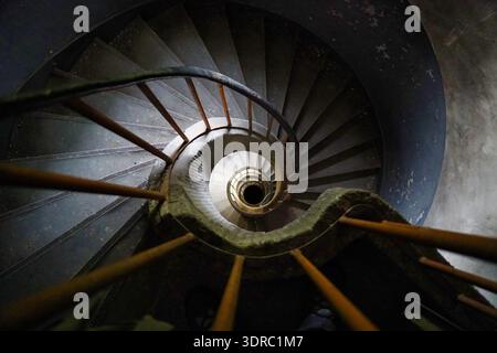 Decay in demolition building; spiral staircase Stock Photo