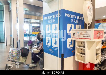 signs for seats for elderly passengers, individuals with disabilities, pregnant women, small children, COVID-19 Awareness, KLUA airport, Malaysia Stock Photo