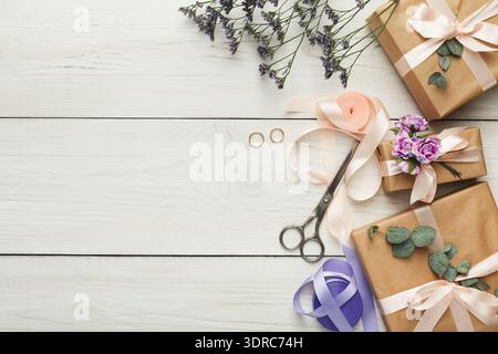 Collage of Wrapped Gifts With Flowers and Tools on a Wooden Surface During a Celebration Stock Photo