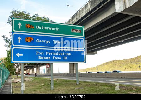 junction in Glugor, Penang, Malaysia, near the Zon Perindustrian Bebas Fasa III, signs provide directions to major destinations Butterworth, George Town Stock Photo
