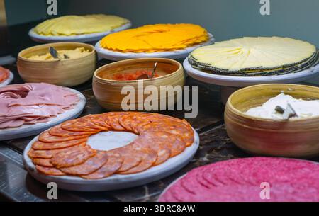 Assorted sliced cheese and cold meat cuts. Stock Photo
