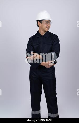 Male technician in blue work uniform with arms crossed Stock Photo