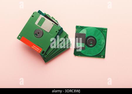 Collection of Green Floppy Disks Arranged on a Light Background With One Disk Beside the Stack Stock Photo