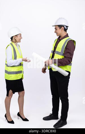 Male and female engineers discussing construction project Stock Photo