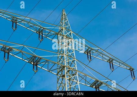A power pole of an overhead line or power line with cables and insulators in bottom view Stock Photo