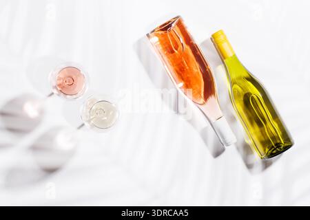 Two wine glasses filled with rose and white wine Stock Photo