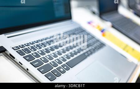 Laptop computers put up for sale in an electronics store. Stock Photo