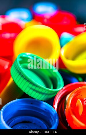Different sorts of colorful plastic bottle caps. Recycling. Stock Photo
