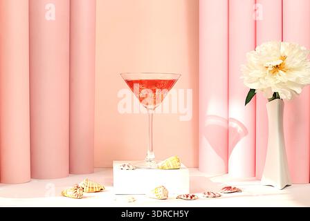 Modern summer still life with pink martini, alcoholic cocktail, seashells and peony flowers on elegant modern background, minima Stock Photo