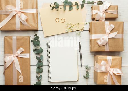 Gift Wrapping Set With Notepad and Rings Displayed on White Wooden Table Stock Photo