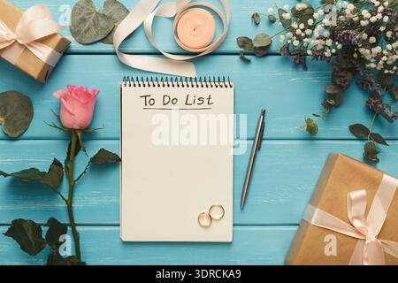 Set of Gifts and a to Do List on a Blue Wooden Table With Flowers and Ribbons Stock Photo