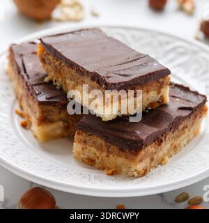 Homemade Vegan cocoa dates chocolate bars with coconut, hazelnuts, walnuts and sunflower seeds on a Stock Photo