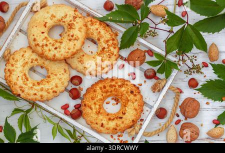 Homemade cookies. Cookies with nuts (hazelnuts, walnuts, almonds, peanuts) in the form of rings on a Stock Photo