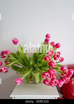 Pink tulip flower bouquet Asymmetrical pink tulip arrangement on table with ample negative space and soft Stock Photo