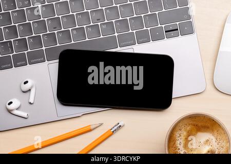 A smartphone with a black screen placed on an office table Stock Photo