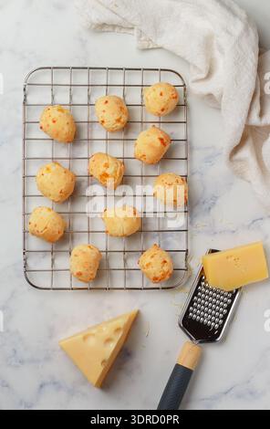 Brazilian cheese bread. Freshly baked homemade cheese buns on a baking rack Stock Photo