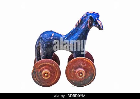 A ceramic children's figurine of a horse on wheels against a light background Stock Photo