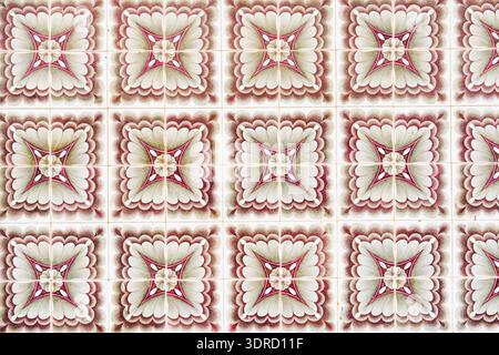 Seamless pink and cream ornamental pattern on square ceramic tiles. Stock Photo