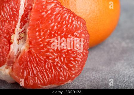 Juicy grapefruit close up on the gray stone table. Selective focus Stock Photo