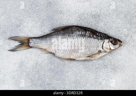 Dried salted fish on grey concrete background Stock Photo