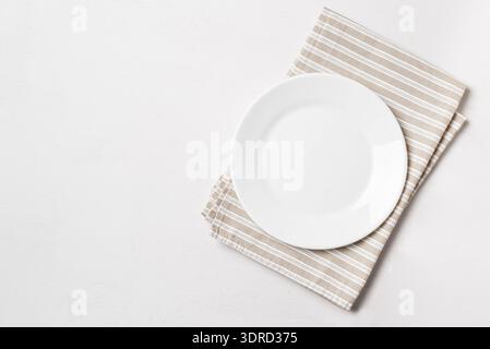 Empty plate with napkin on white background Stock Photo