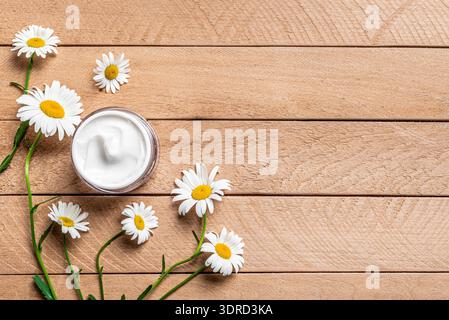 Natural organic face cream with chamomile flowers Stock Photo