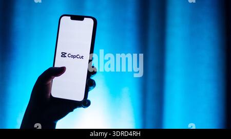 Kaliningrad, Russia - 12.11.2025. Smartphone screen in woman hands displaying logotype of popular application for video editing CapCut. Video edit app Stock Photo