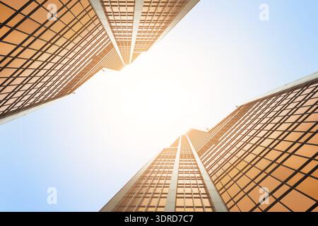 Tall Buildings Reach for the Sky in a Bright Urban Scene With Sunlight Shining Through Stock Photo