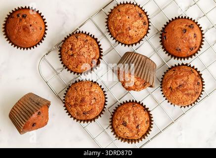 Homemade banana muffins with chocolate chips and salted caramel on a marble background. Delicious an Stock Photo