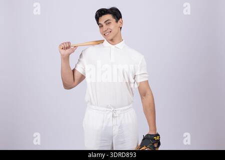 Young man holding a baseball bat on his shoulder Stock Photo