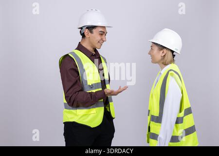 Two construction workers in safety gear discussing a plan Stock Photo